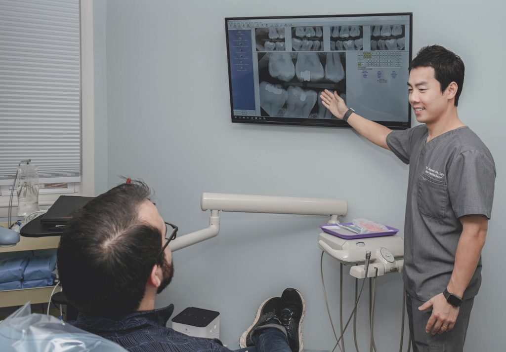 Dr Shawn Kim, DDS, Ace Dental Boston going over x-ray results