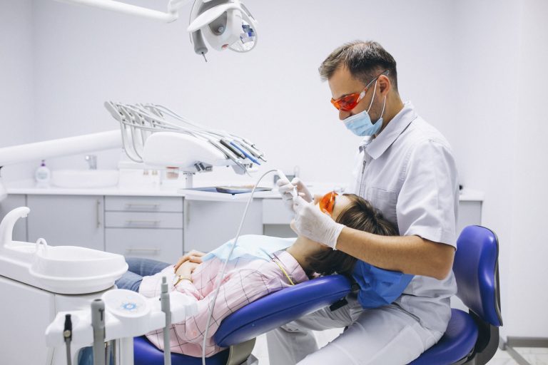 Female patient sitting in dentist chair getting dental work done