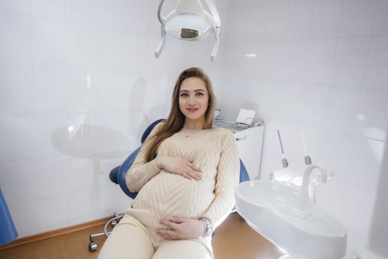 Pregnant female sitting in a modern dental office