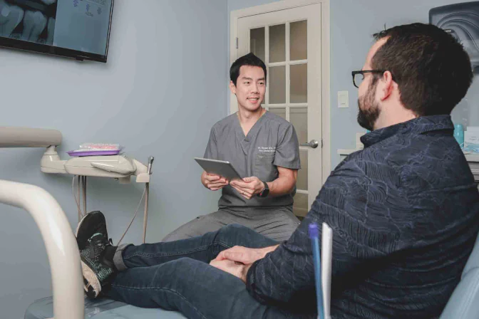 Dr. Shawn Kim consulting a patient at Ace Dental in Boston, MA